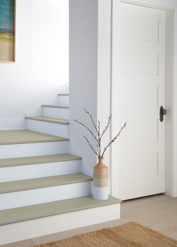 A simple staircase with steps painted in a light grey-green colour