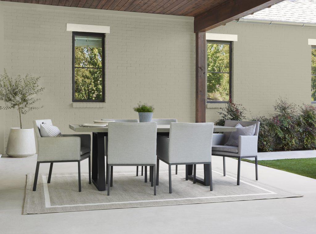A contemporary outdoor area with a dining table set 