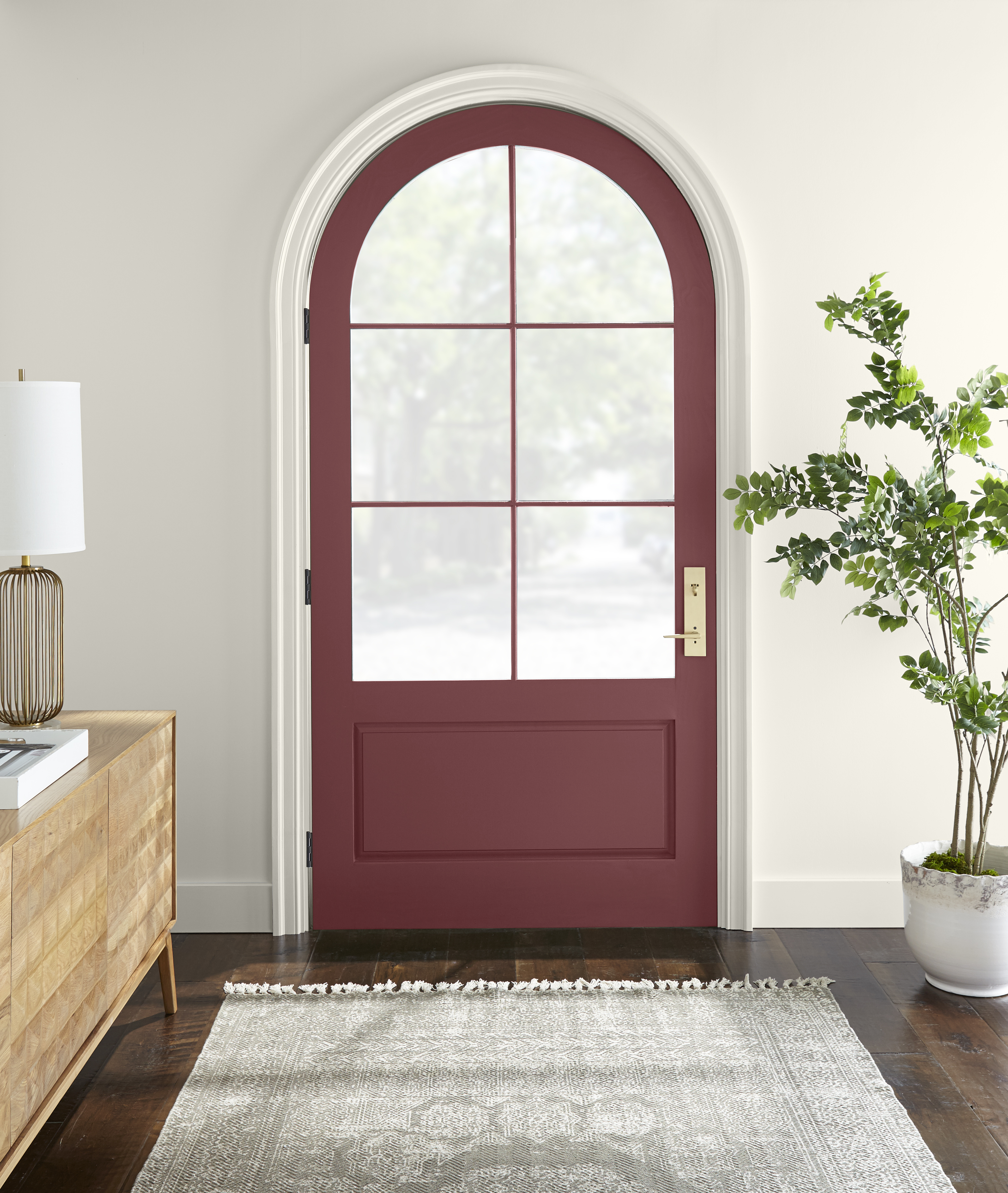 An entryway with the door painted in a red colour.