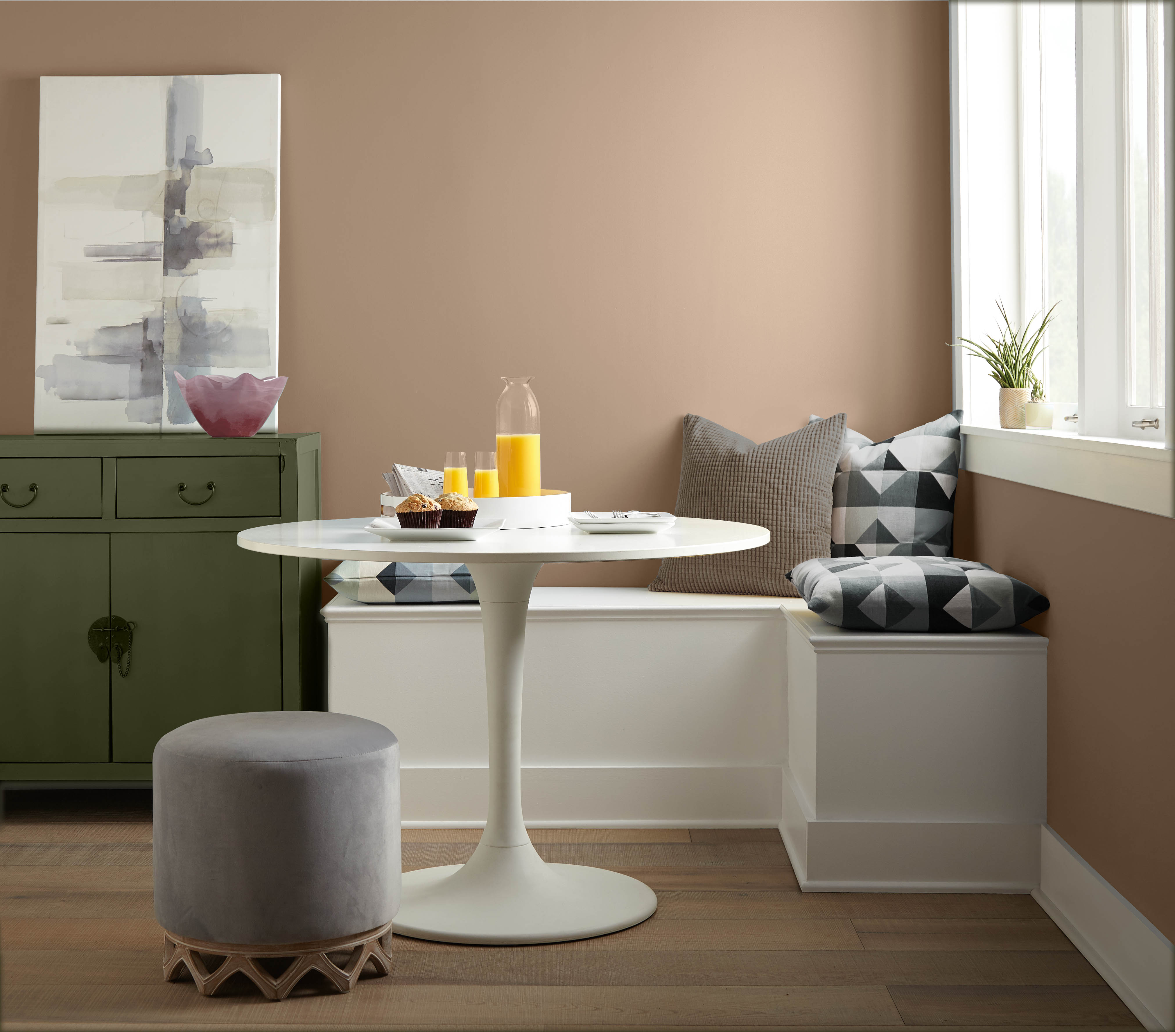 A kitchen nook with warm tan walls and a green cabinet.