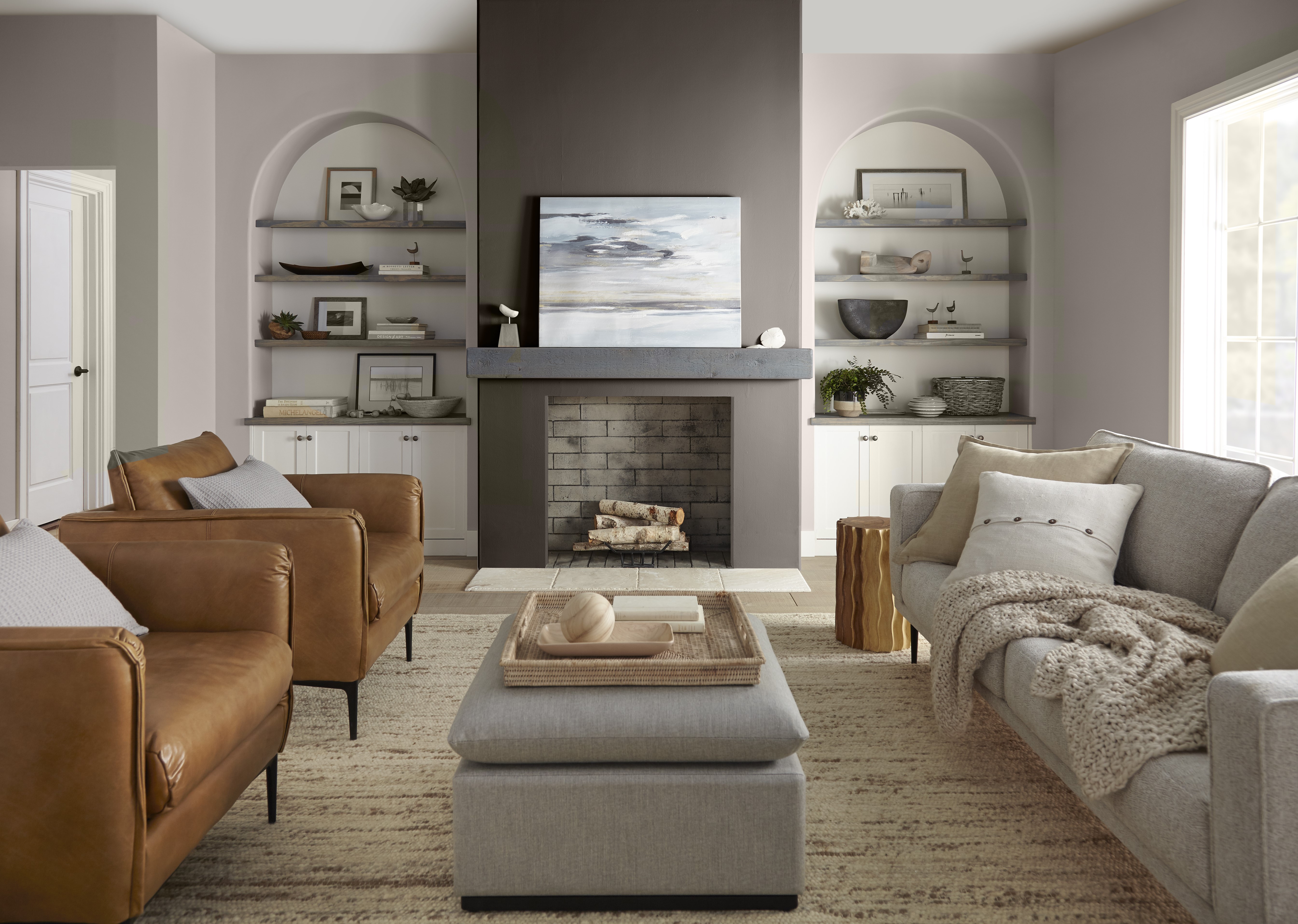 A casual living room with a fireplace featuring a dark brown accent colour. The furniture and are (is) well coordinated with natural and neutral tones. 