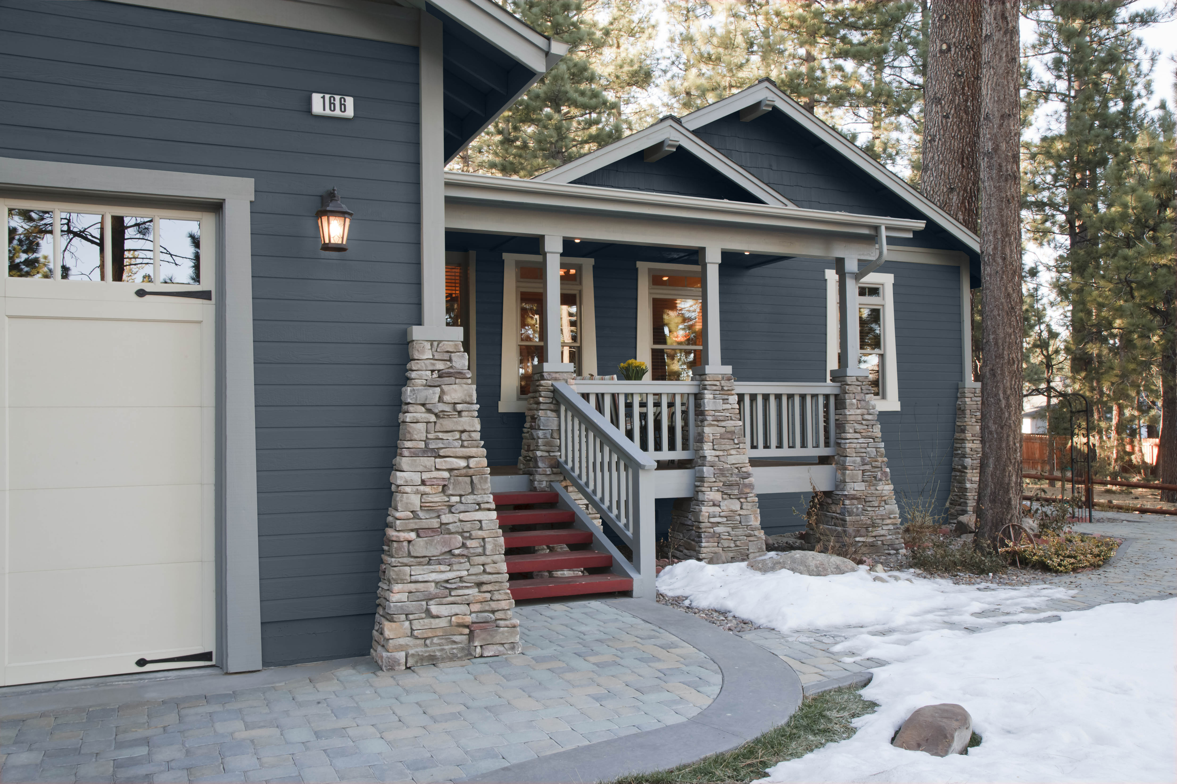 An exterior home painted in a deep blue hue.