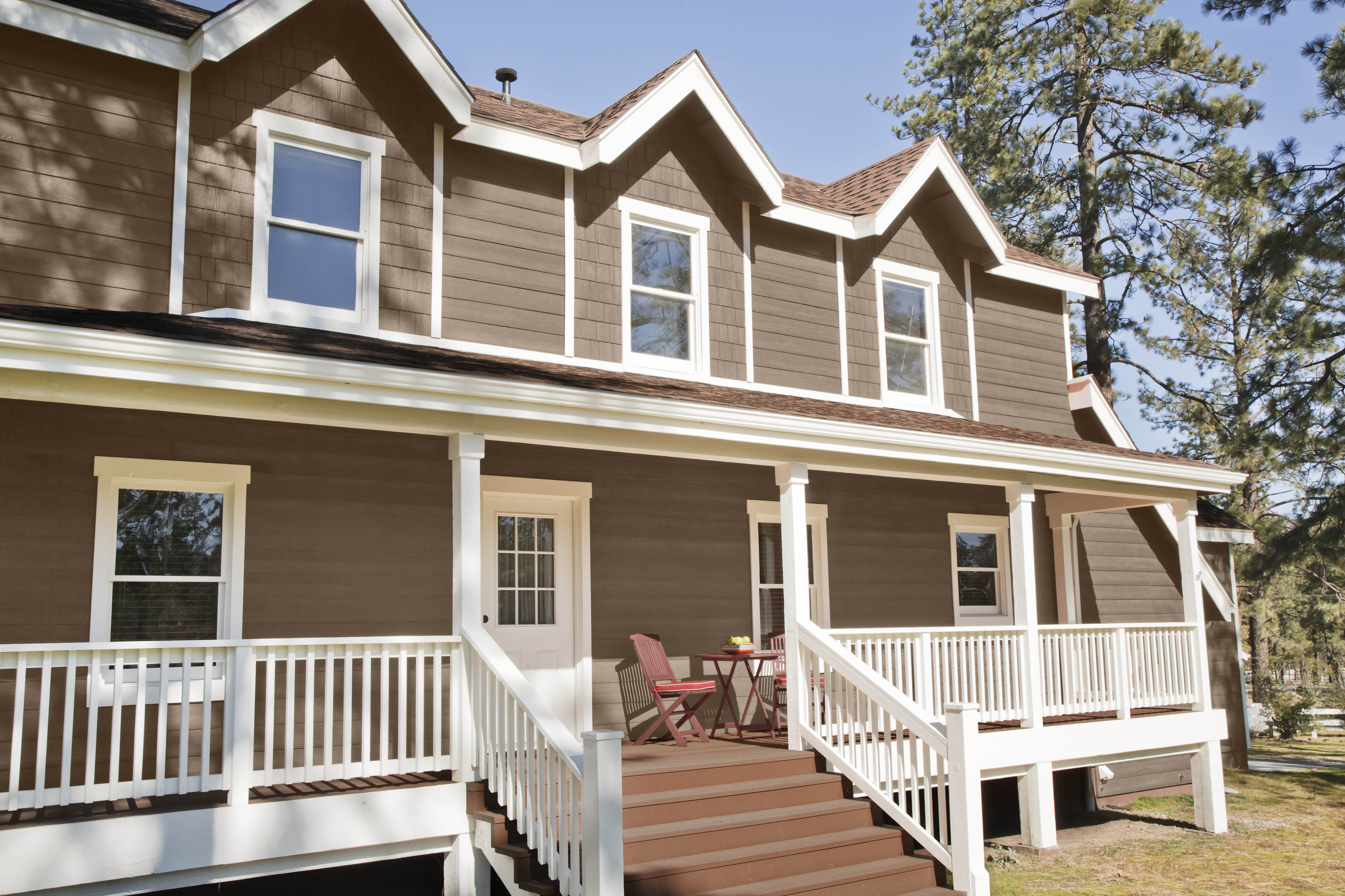 An exterior home painted in a medium brown hue.