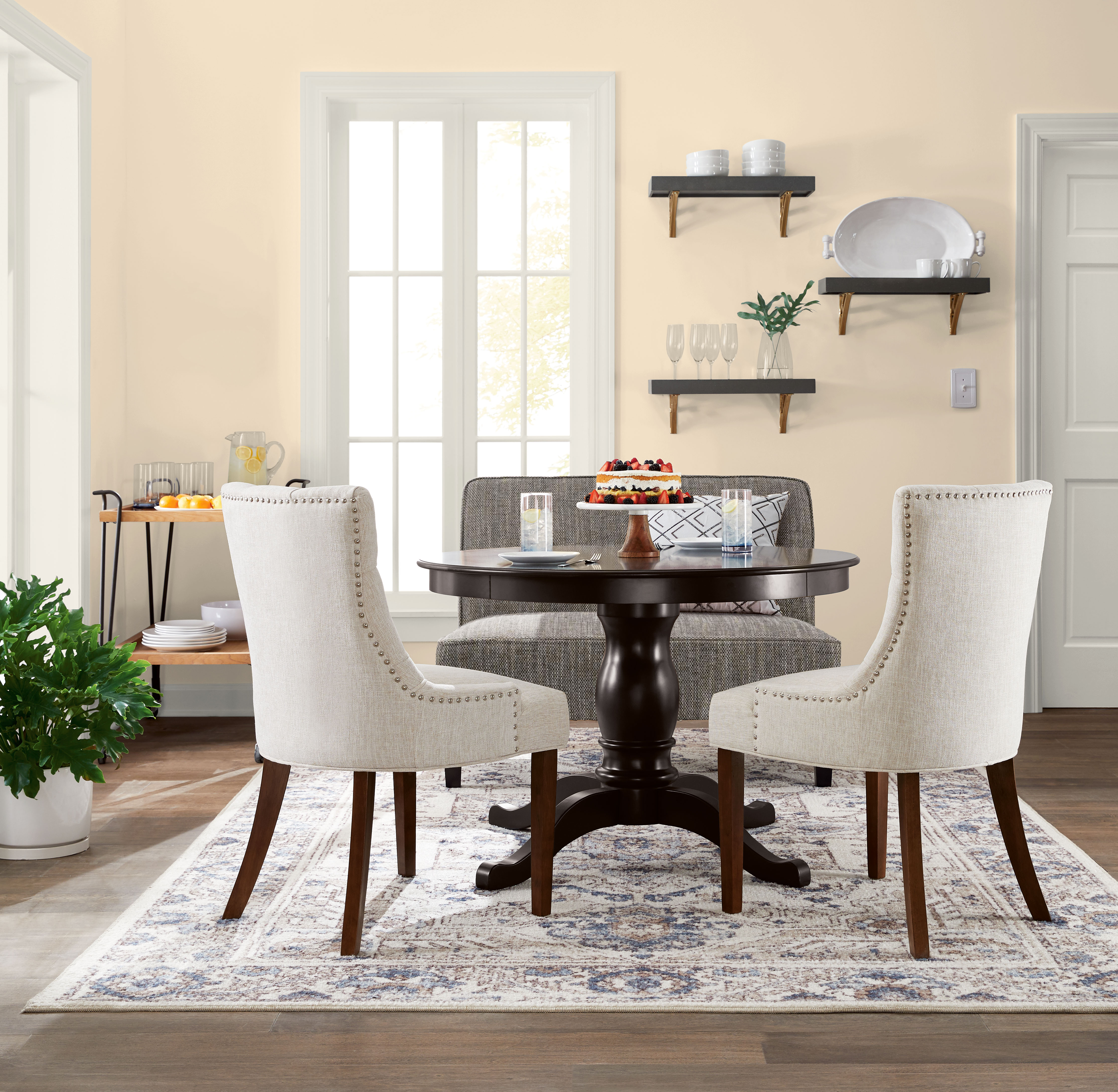 left image shows a relaxing bedroom with a bed, side chair and glass vase with some flowers. Right Image shows a warm dining room with a table, chairs and décor. 