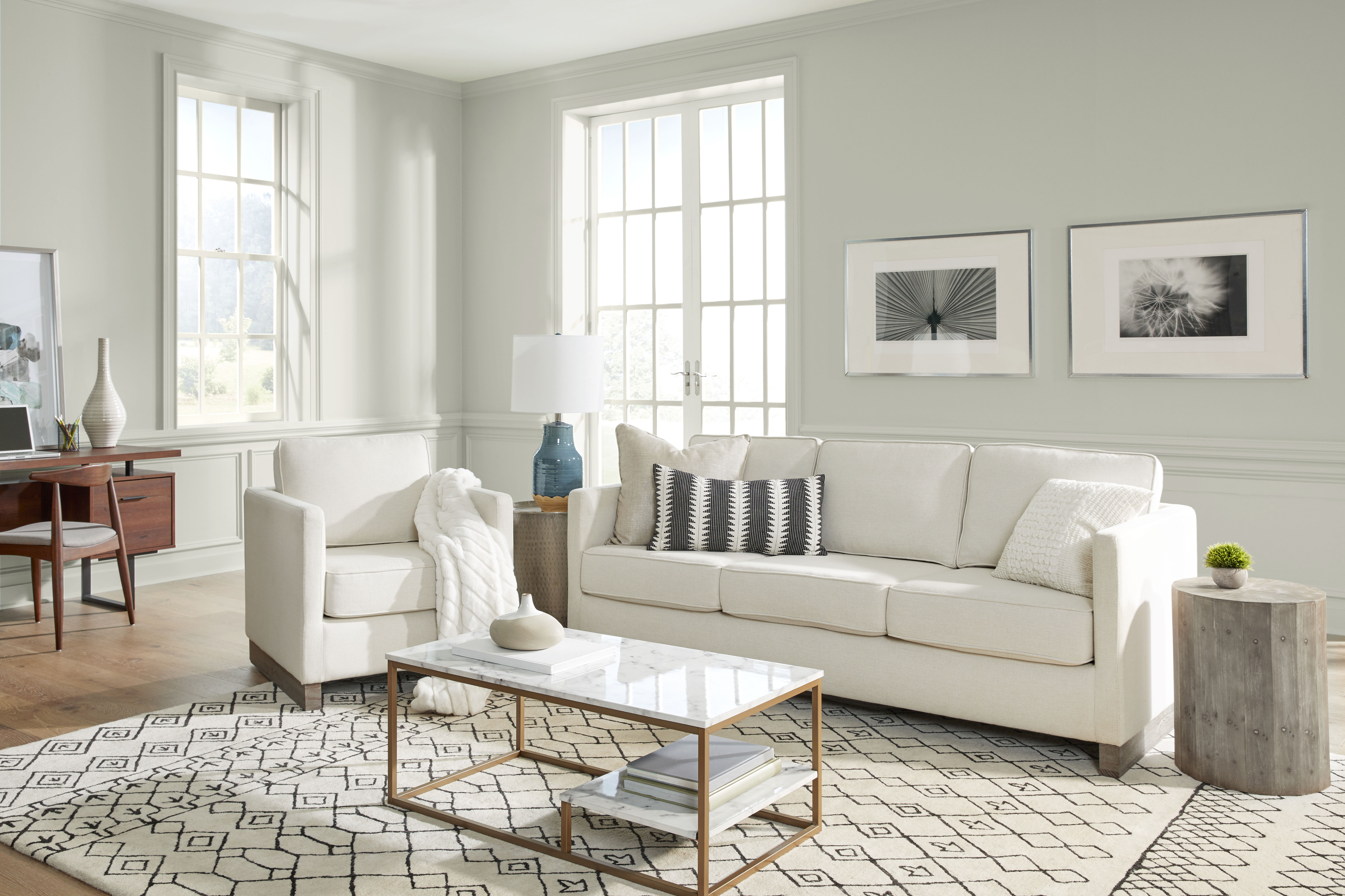 living room image that gives an open and airy feeling with white walls, white creamy furniture and decorative elements throughout the space. 