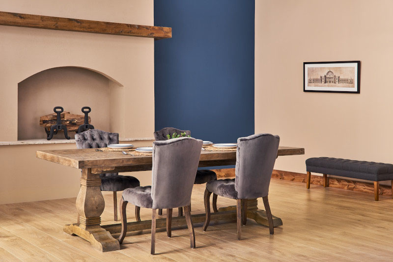 Dining room with fireplace, wooden dining table with chairs. 