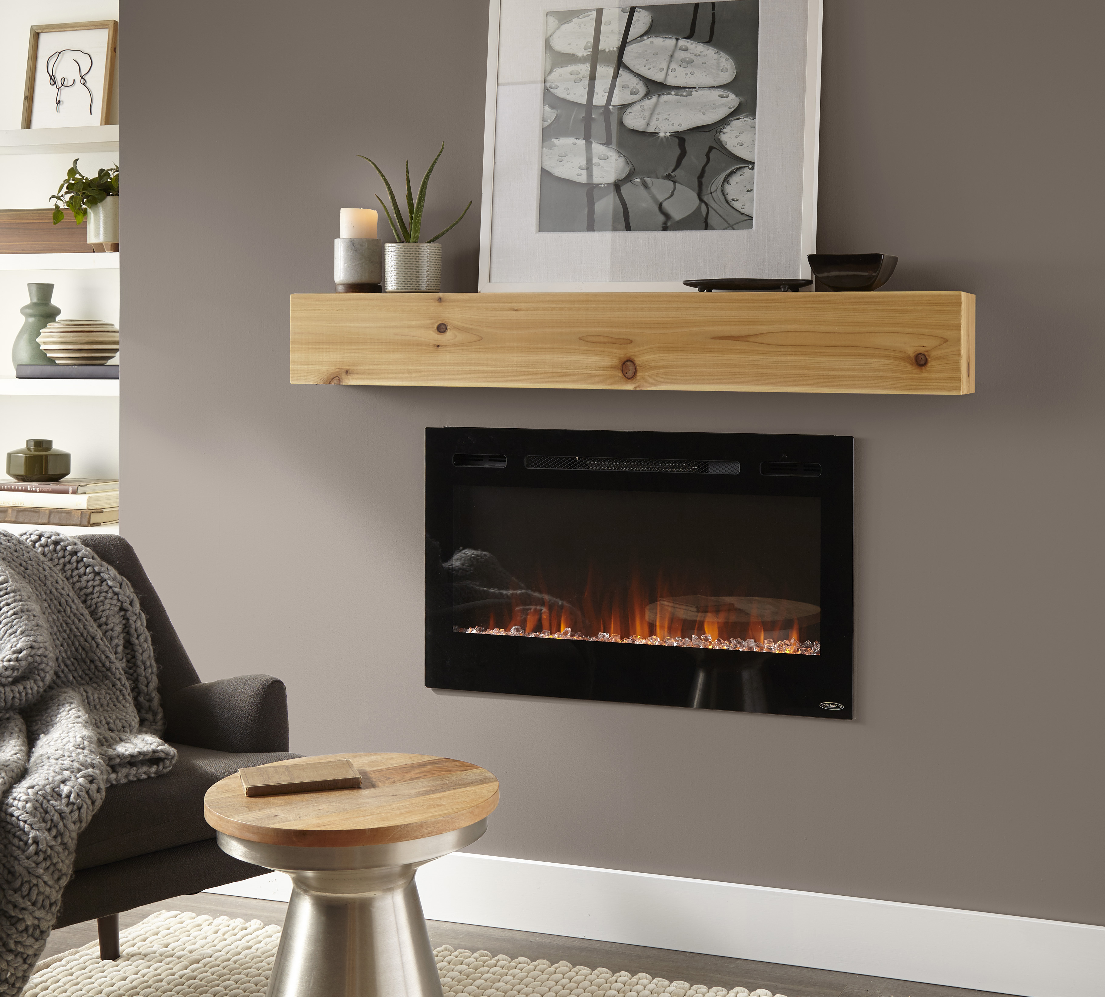 A fireplace with the wall behind painted in a deep taupe-grey colour.