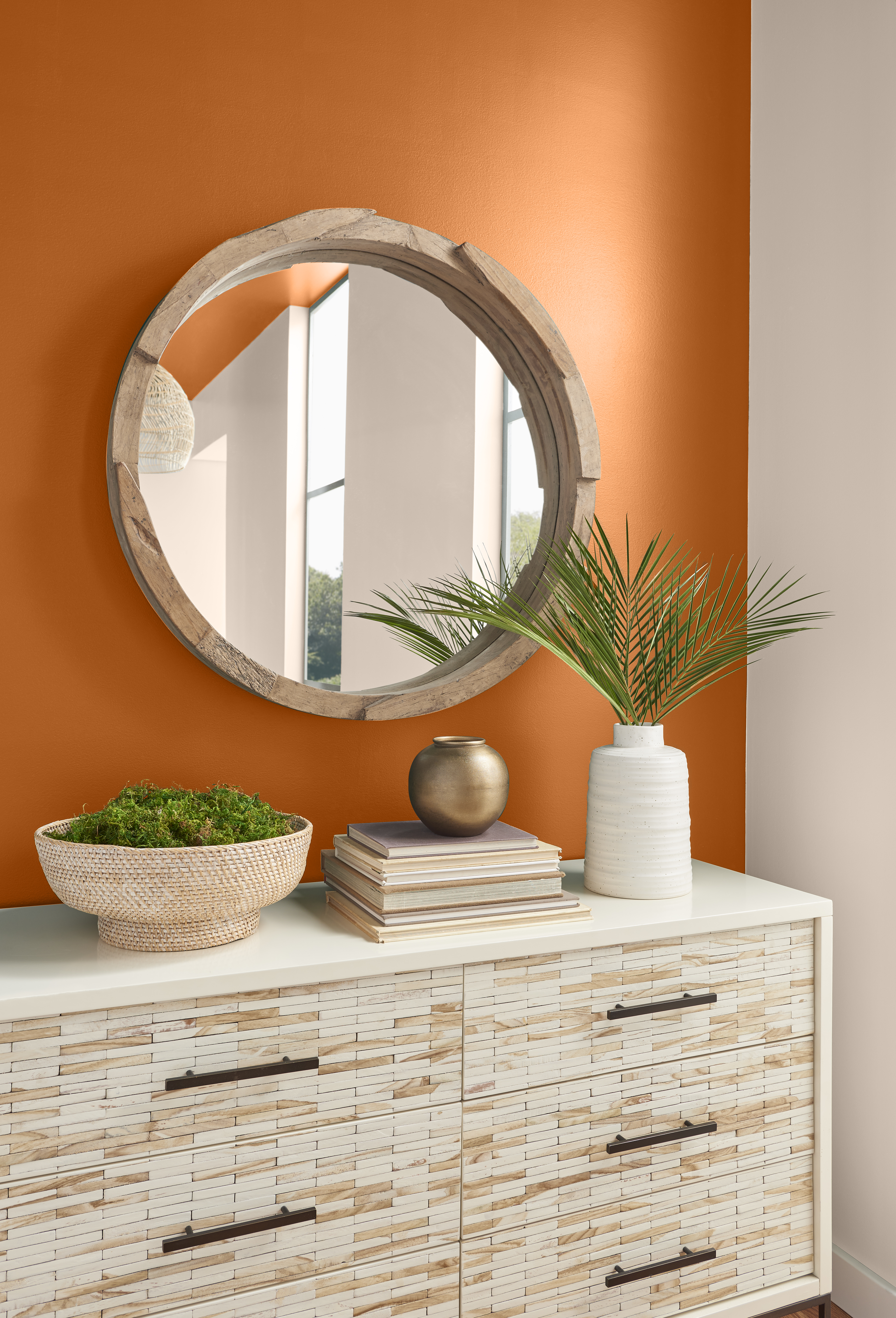 A simple setting with the wall painted in a vibrant orange hue.